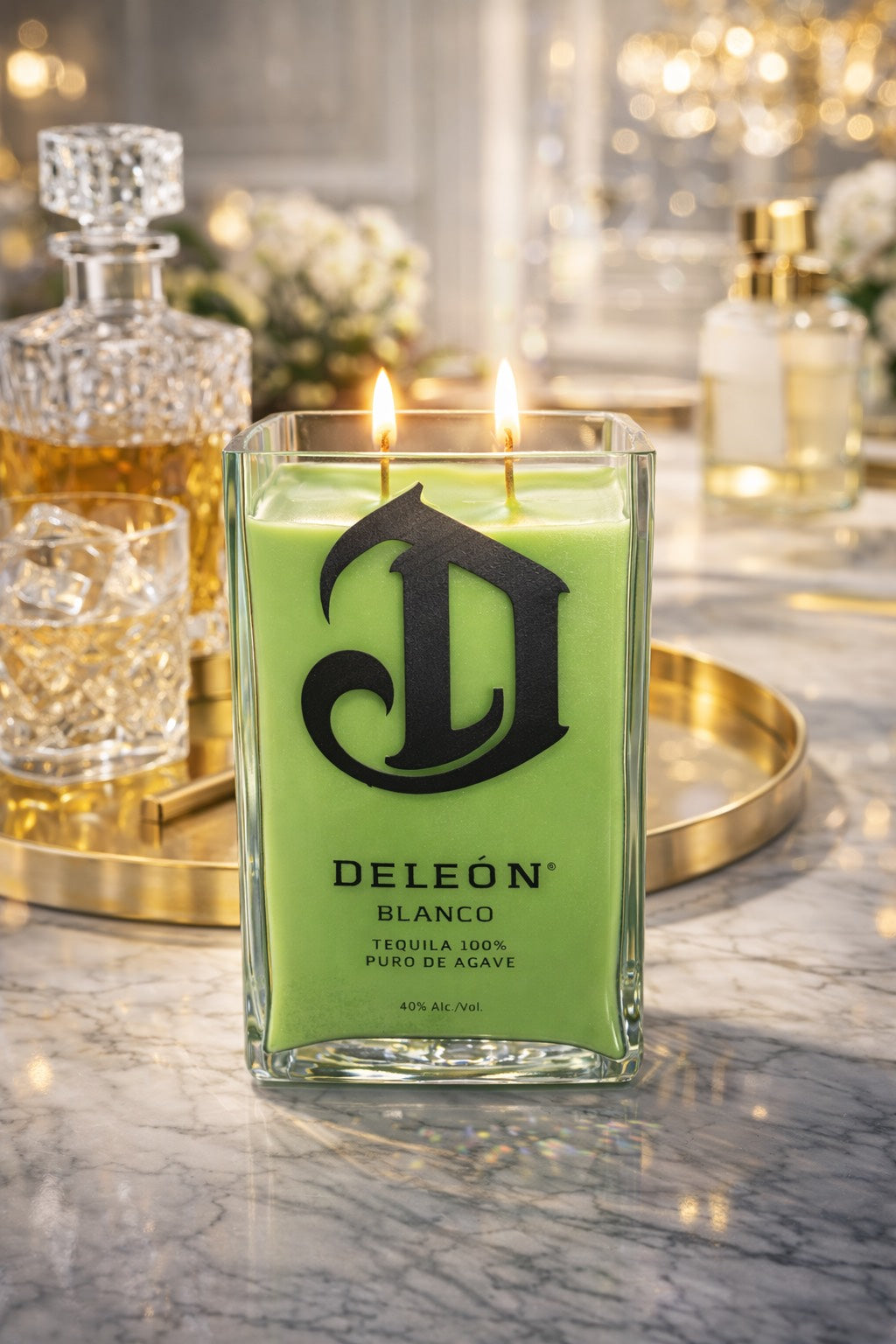 DeLeon tequila bottle candle on a marble surface with decorative background