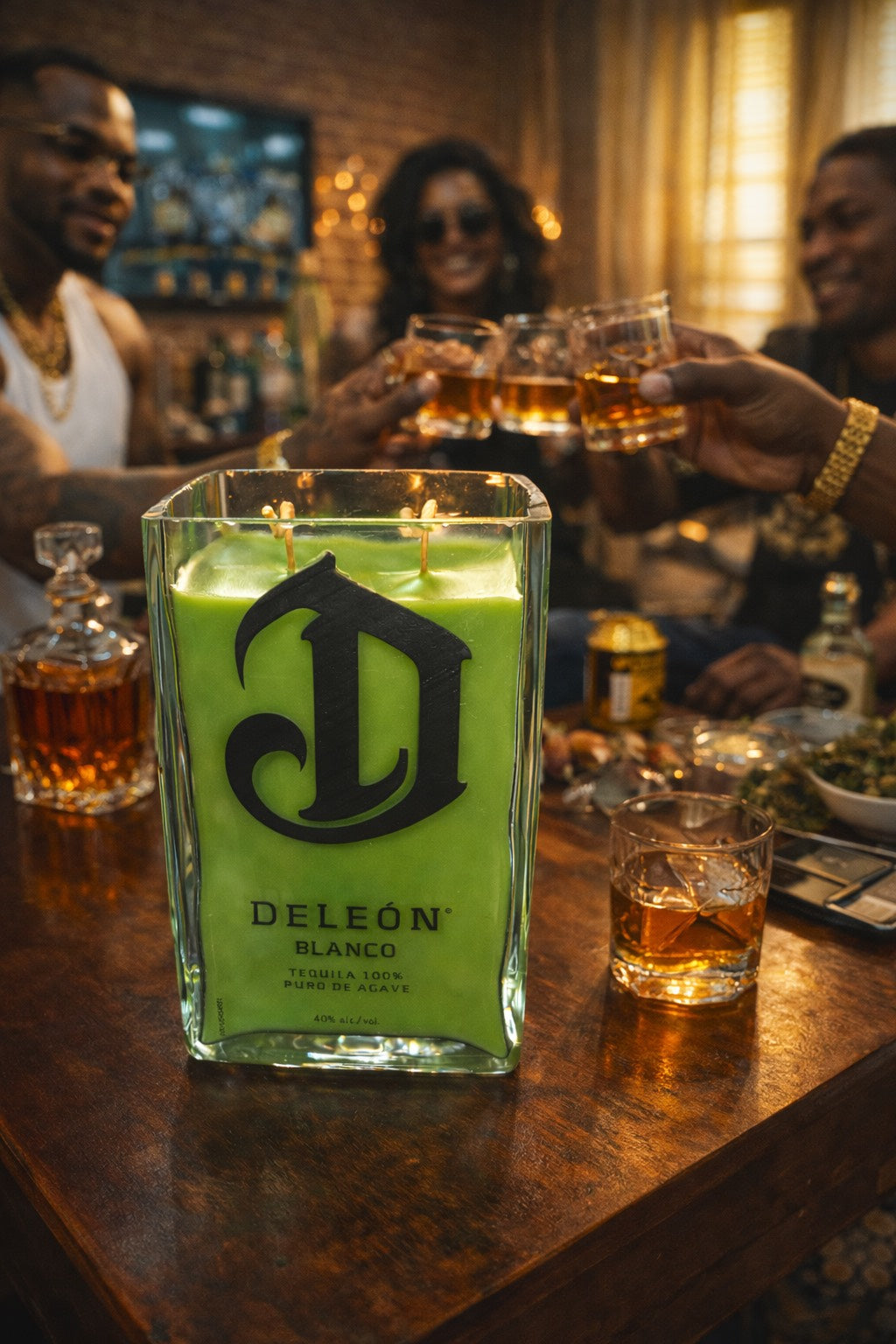 Deleñ tequila bottle with green candle on a bar counter with people in the background.